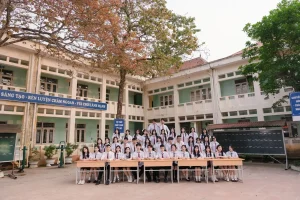 Cả lớp chụp kỷ yếu cùng bàn học trước dãy phòng học