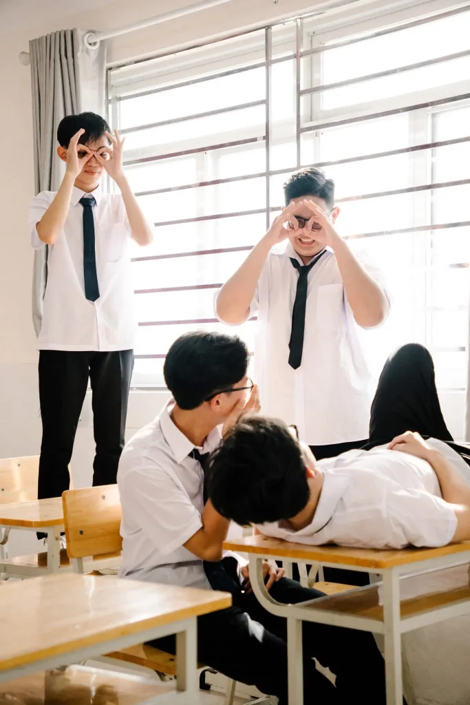 Nhóm học sinh tạo dáng cùng bàn học và cửa sổ